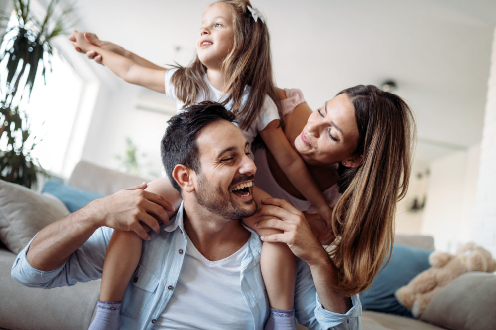 Family in home happy, celebrating, home insurance